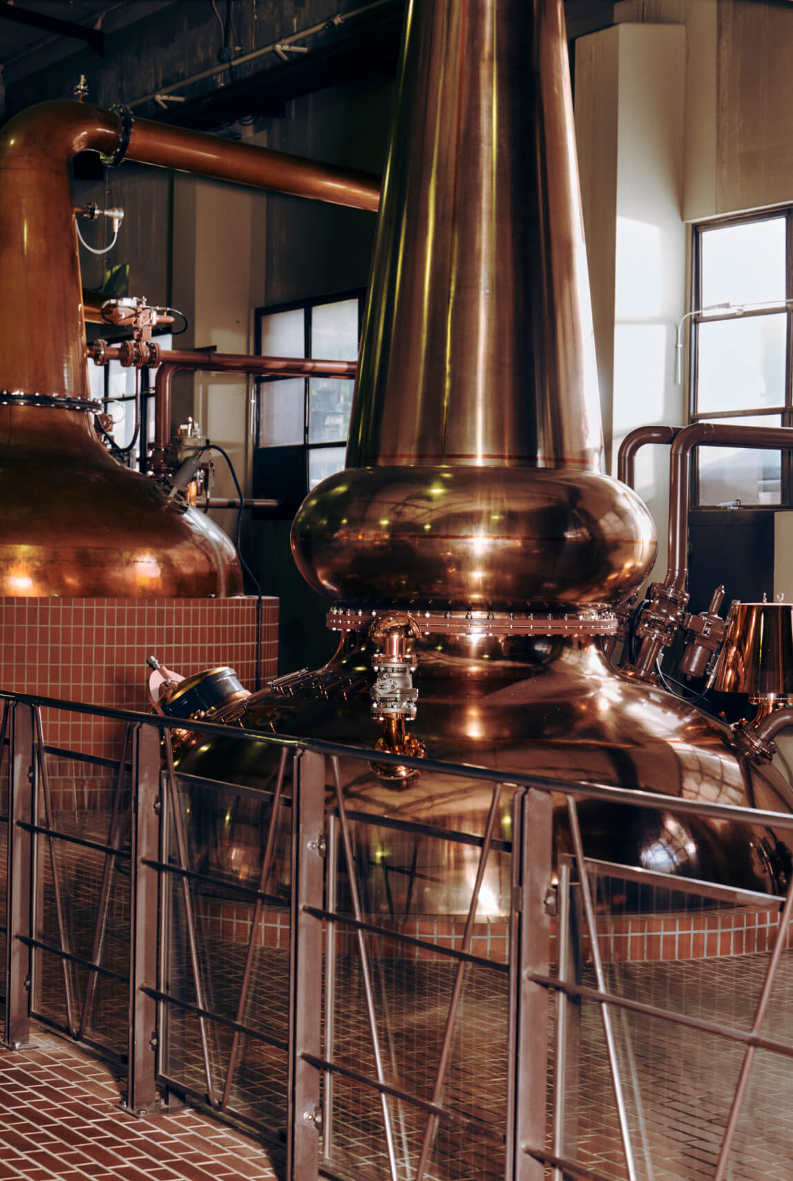Photo of copper stills, where the whisky is distilled, at the Yamazaki Distillery