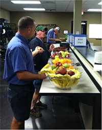 Photo of employee eating fruit.